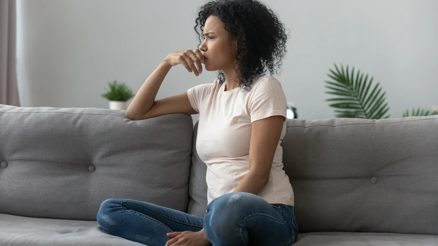 Concerned woman sitting on a couch